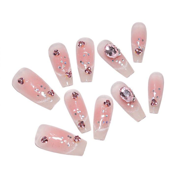 Artificial nail extensions with artistic glitter accents Stornfield