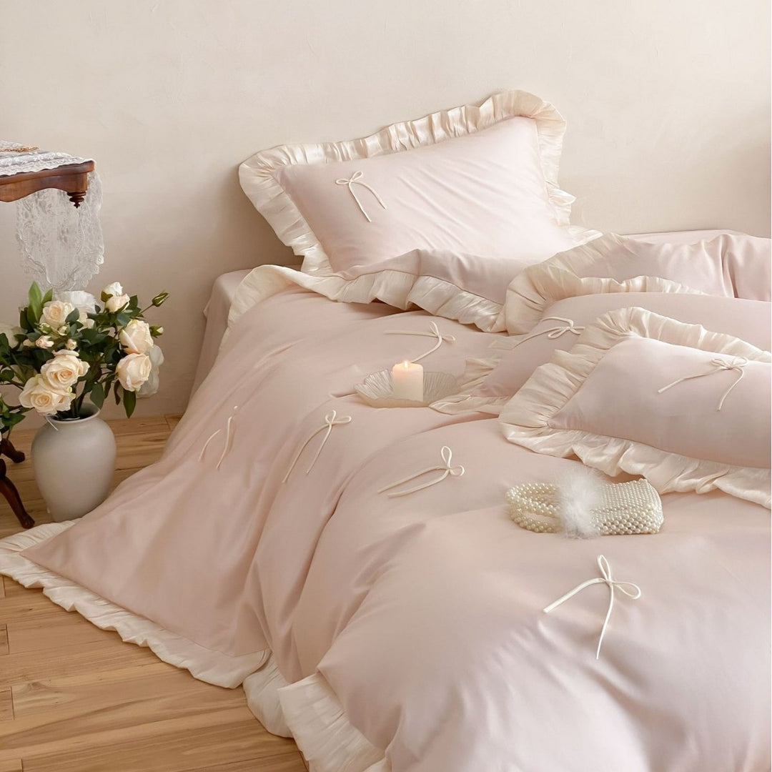 Satin bedding set with ruffle edges, delicate bow appliqué and pillowcases