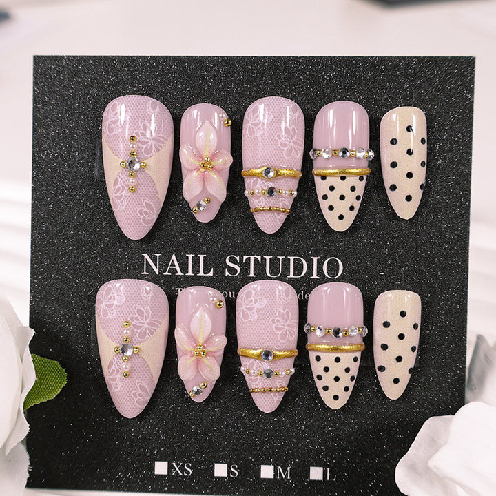 Artificial nail set with delicate floral patterns and elegant accents Stornfield