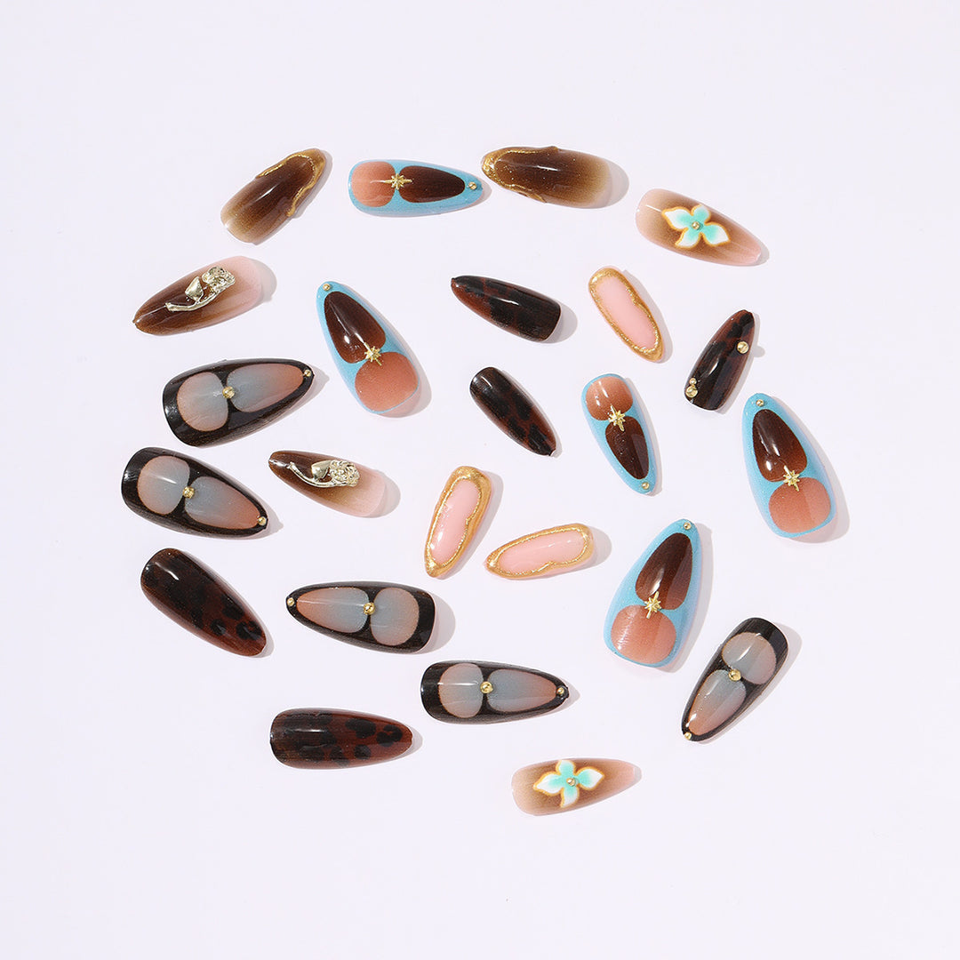 Artificial nail set with luxurious gold design and floral accents Stornfield