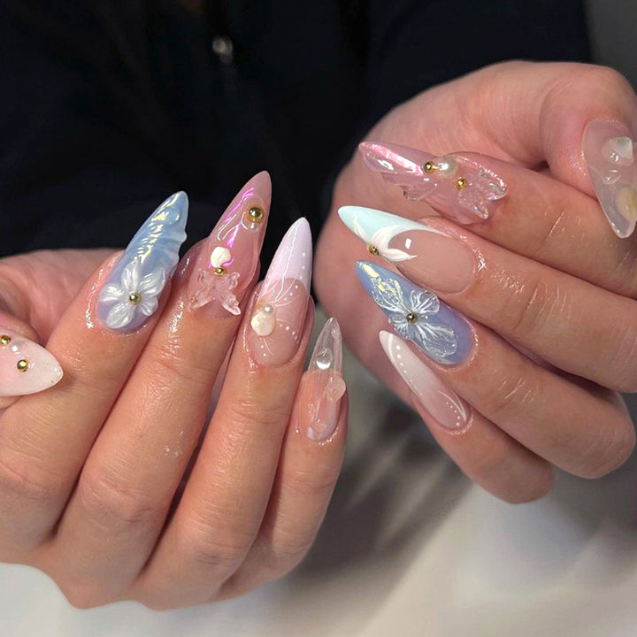 Artistic stiletto nails with delicate flower and glitter embellishments Stornfield