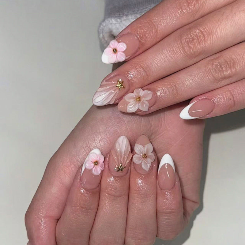 Elegant artificial nails with floral design and glitter accents Stornfield
