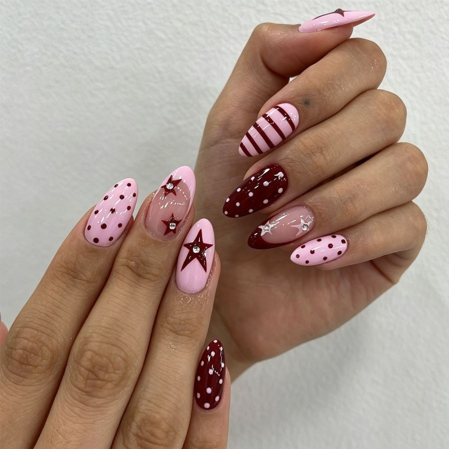 Artificial nail set with asymmetric designs and glitter accents Stornfield