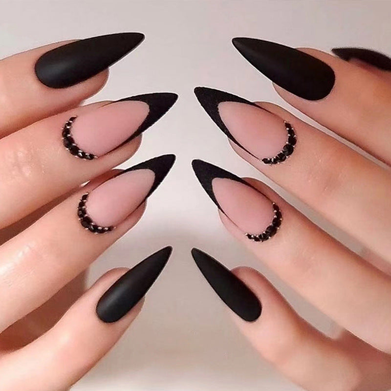 Artful stiletto nails with elegant black design and glitter accents Stornfield