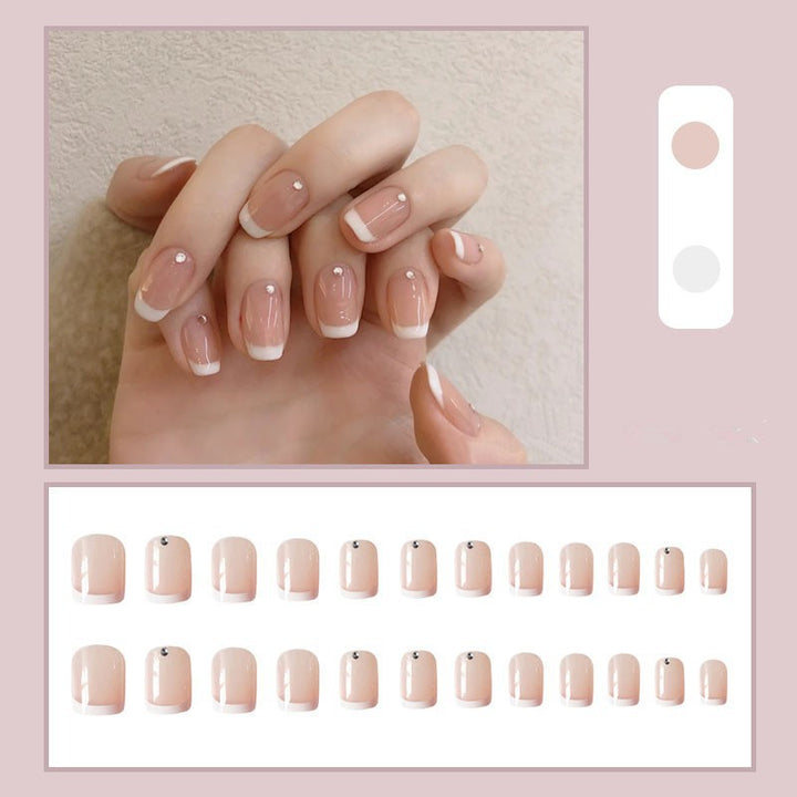 Artificial nails with elegant French tip and rhinestone accents Stornfield