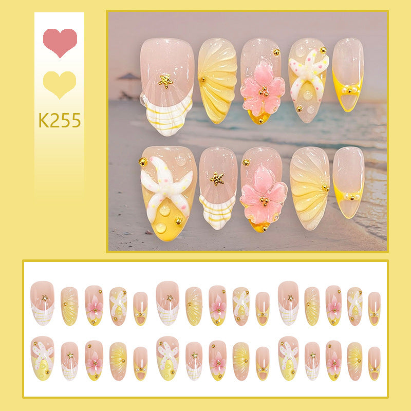 Artificial nail set with glamorous floral designs and creative glitter accents Stornfield