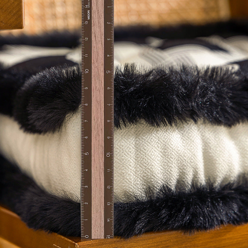 Padded seat cushion with fastening straps and faux fur edge