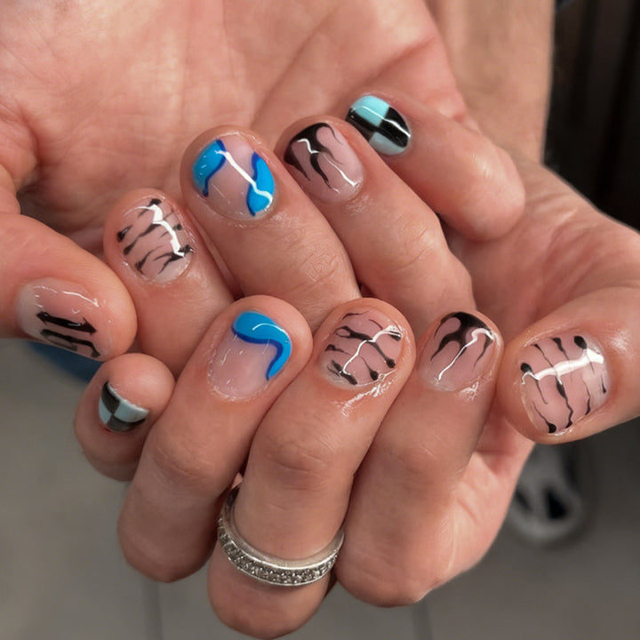 Nail set with modern graphic designs and shimmering accents Stornfield