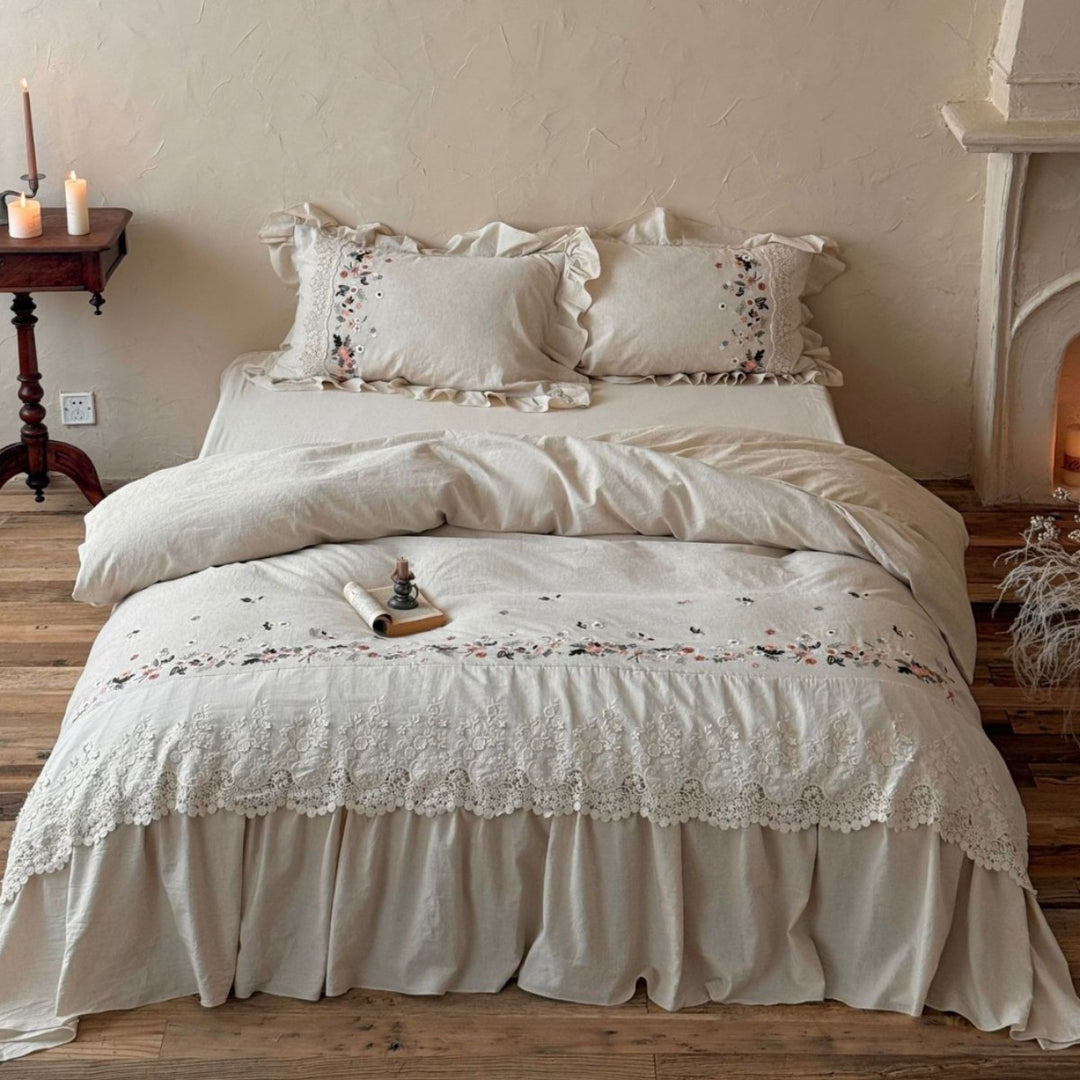 Romantic bedding set in country house style with embroidered border, frill and lace appliqué