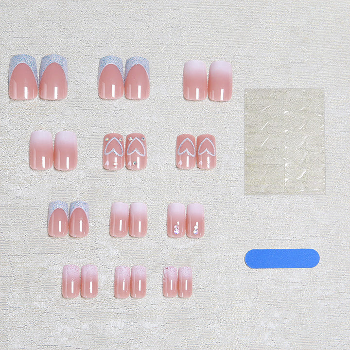 Artificial nails with sparkling heart designs and glitter details Stornfield