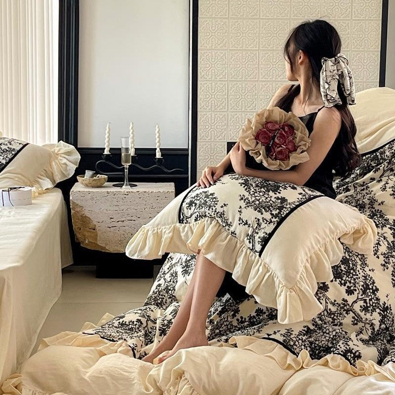 Romantic reversible bedding set made of fine cotton satin with ruffled flounces and toile design