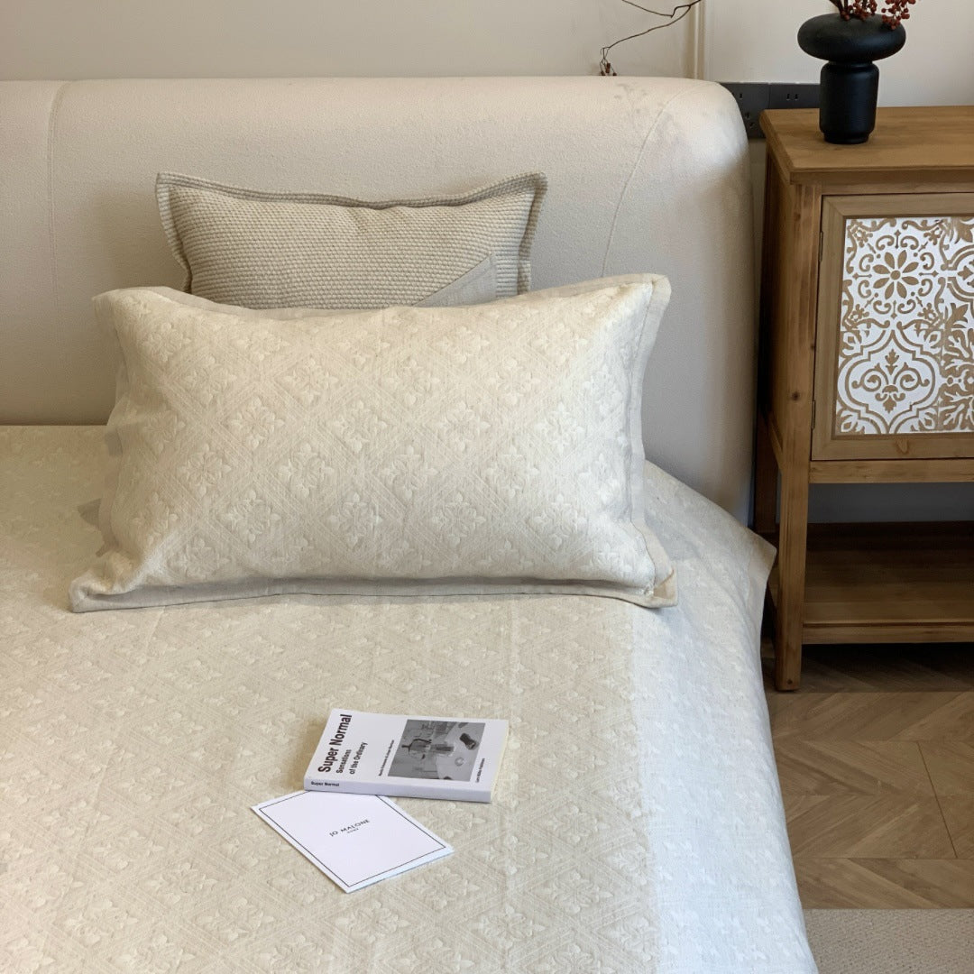Jacquard cushion cover with quilted diamond pattern and piping