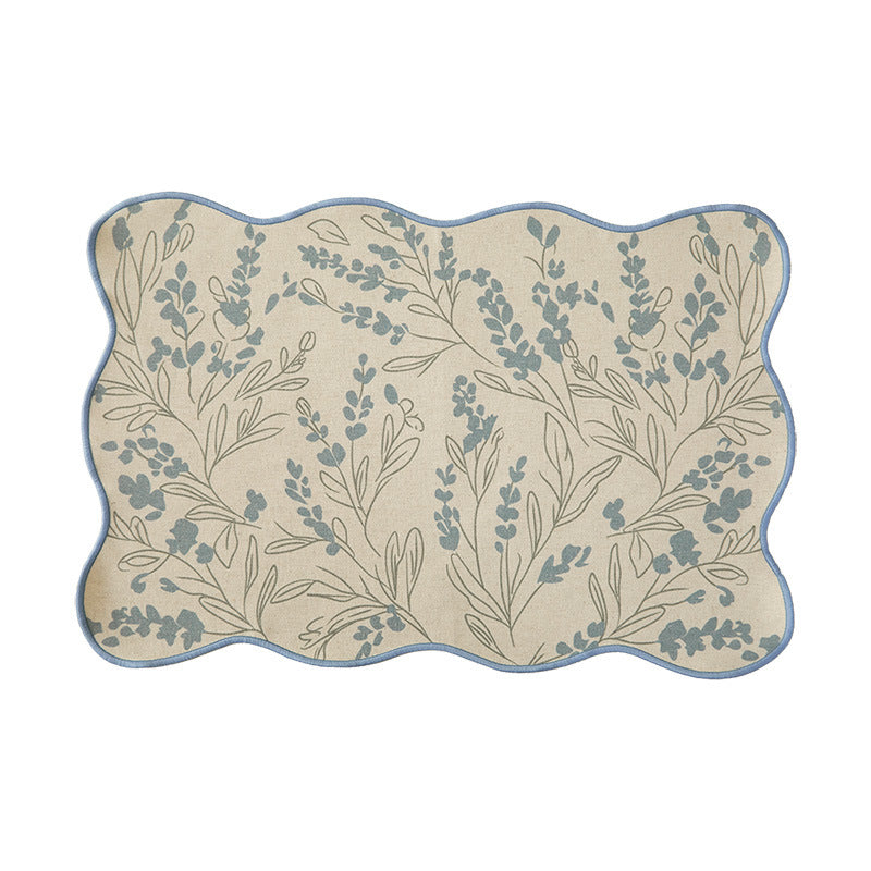 Shaped placemat made of cotton-linen with wavy edge and leaf pattern