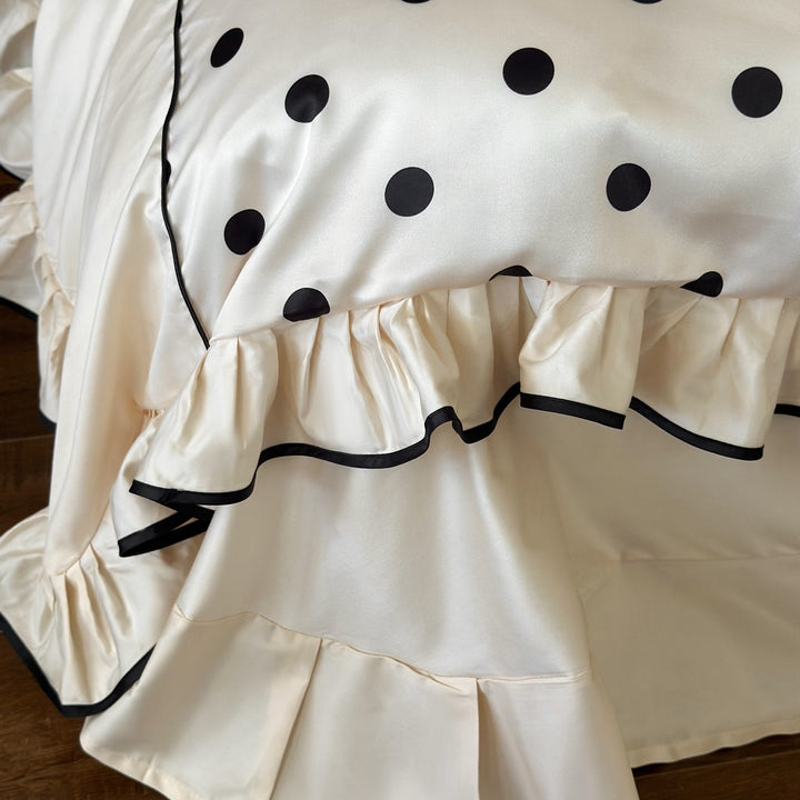 Romantic satin bedding set with ruffles, dots, and fine piping