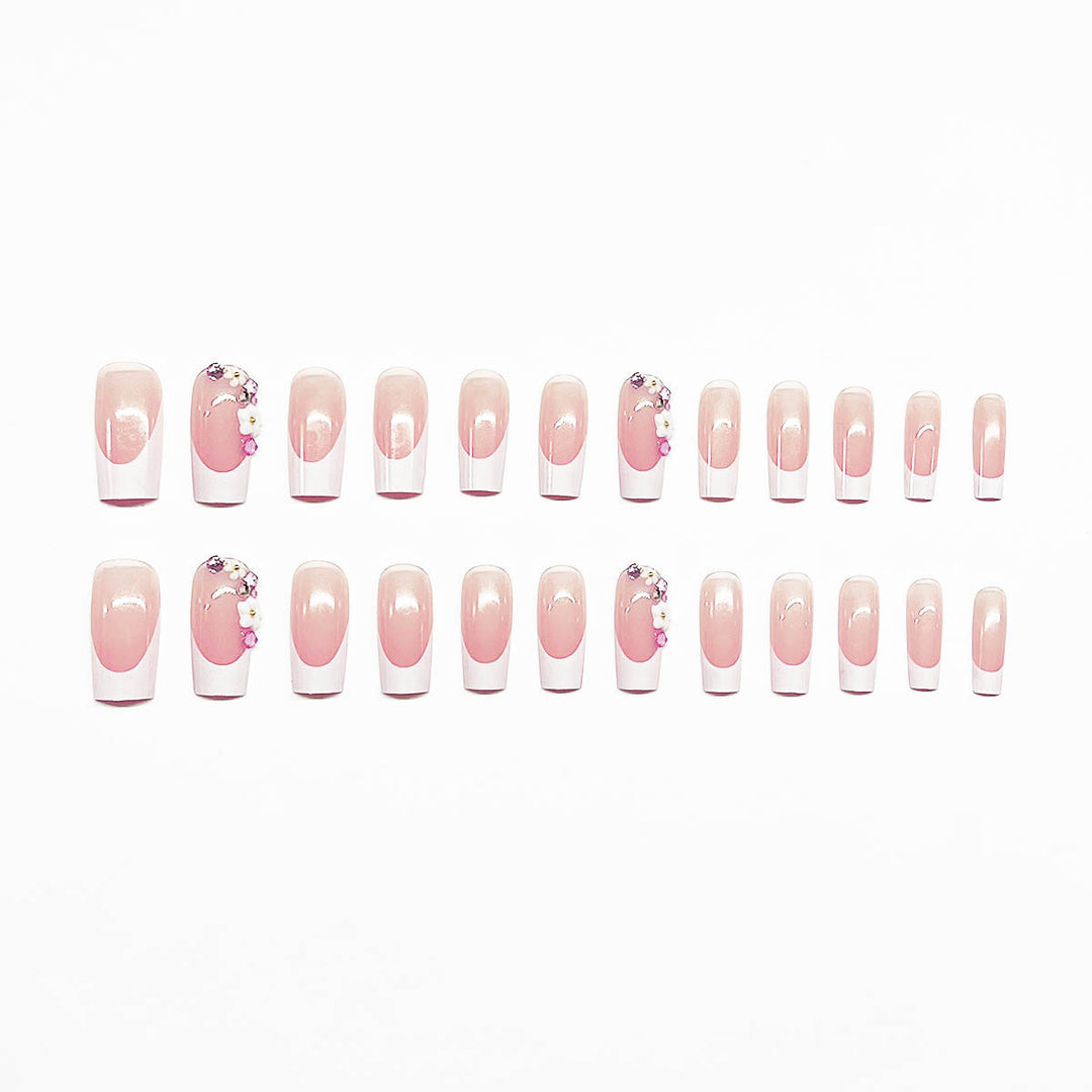 Artificial nail set with elegant floral decorations and transparent finish Stornfield