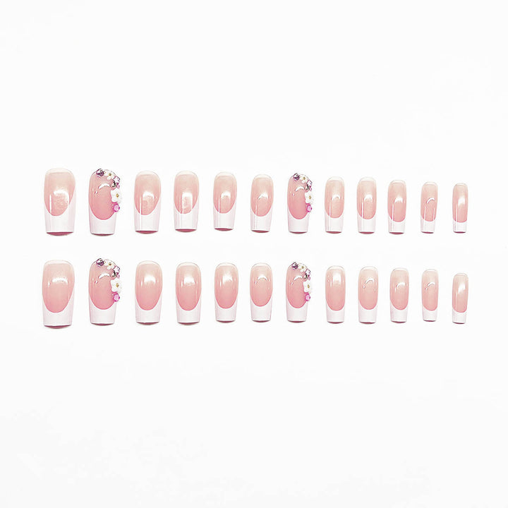 Artificial nail set with elegant floral decorations and transparent finish Stornfield