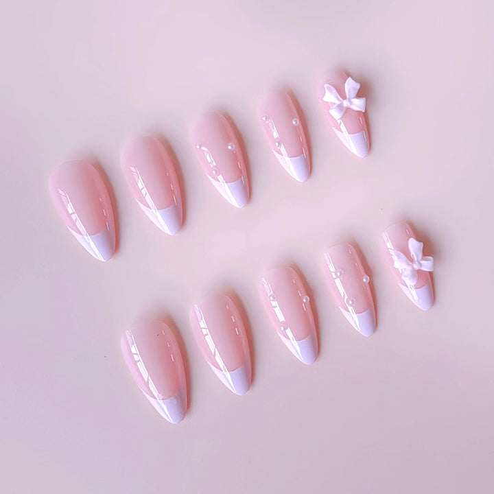 Artificial nail set with shimmering 3D bows and elegant pearl accents Stornfield