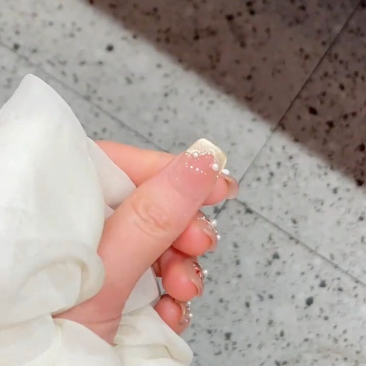 Artificial nails with elegant pearl and flower accents Stornfield