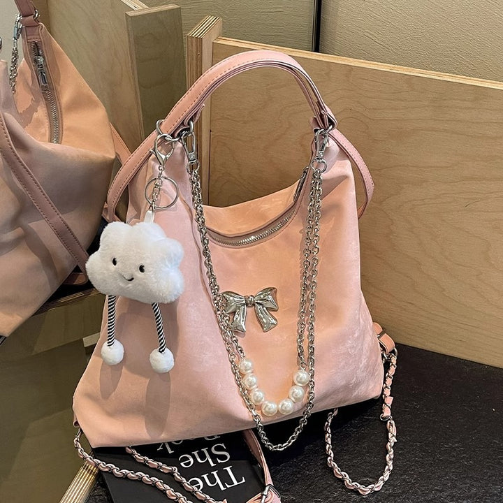 Fashionable handbag with unique pendant and chain accents Stornfield