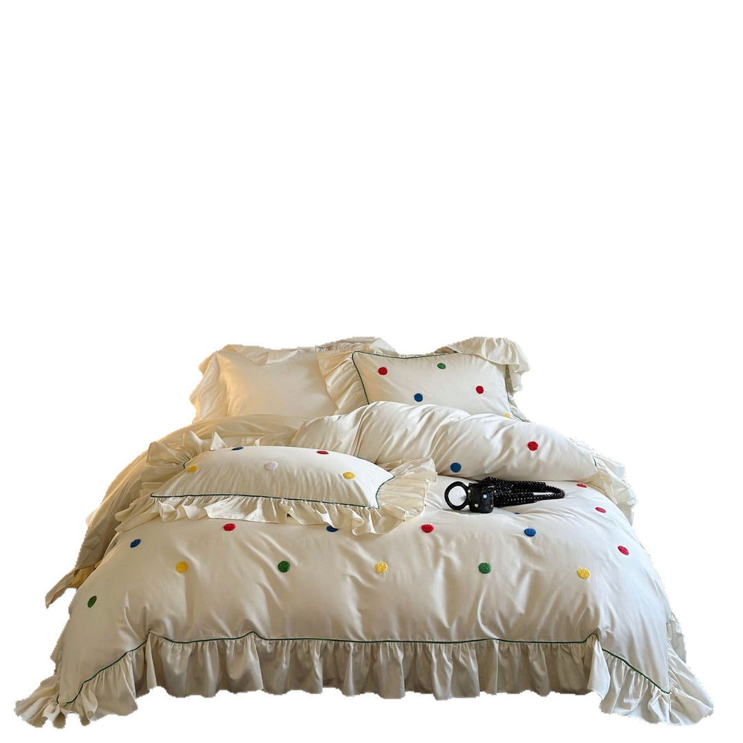 Playful bedding set with frill, colorful flock applications, and fine piping