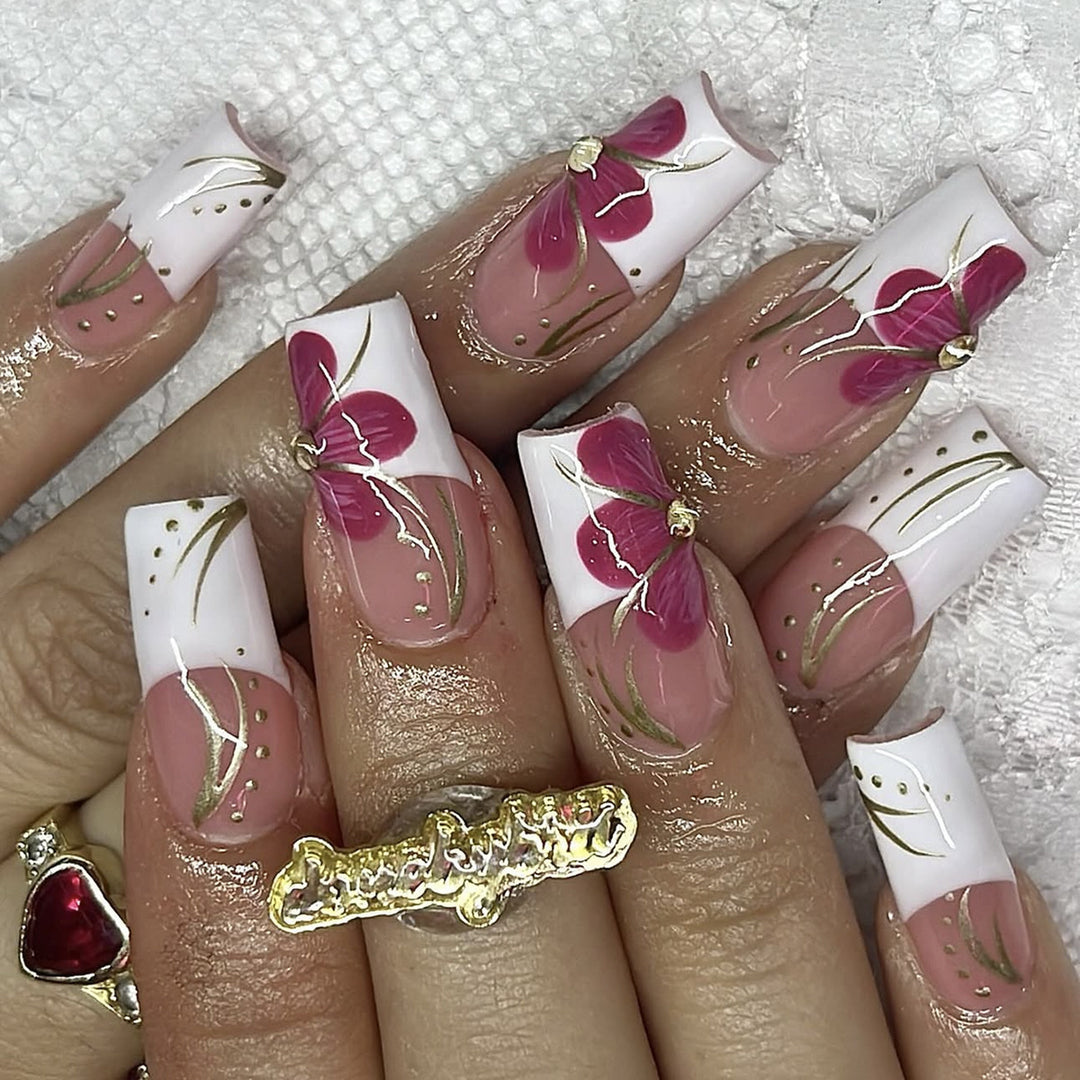 Artificial nail set with floral detail and glitter accents Stornfield
