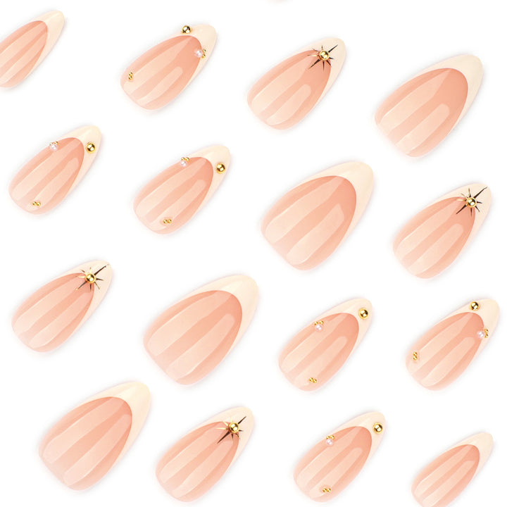 Artistic French-tip nail art with glitter and elegant embellishments Stornfield