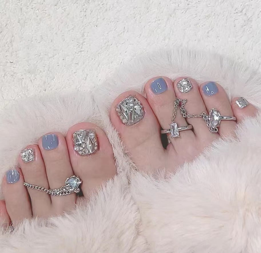 Artistic toenail art with rhinestone and glitter elements Stornfield
