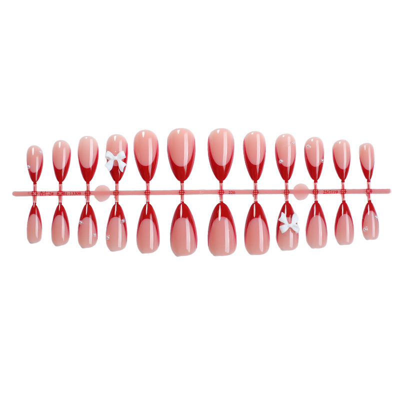 Artificial nail set with elegant bows and glitter accents Stornfield