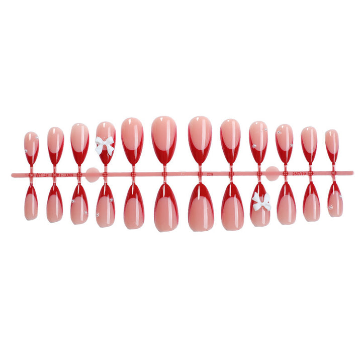 Artificial nail set with elegant bows and glitter accents Stornfield