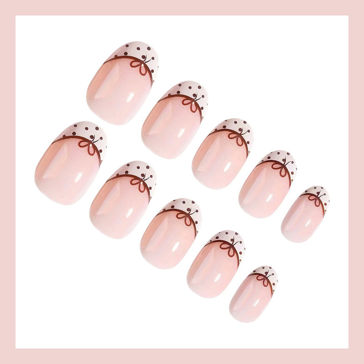 Artificial nail set with elegant bow and dot patterns Stornfield