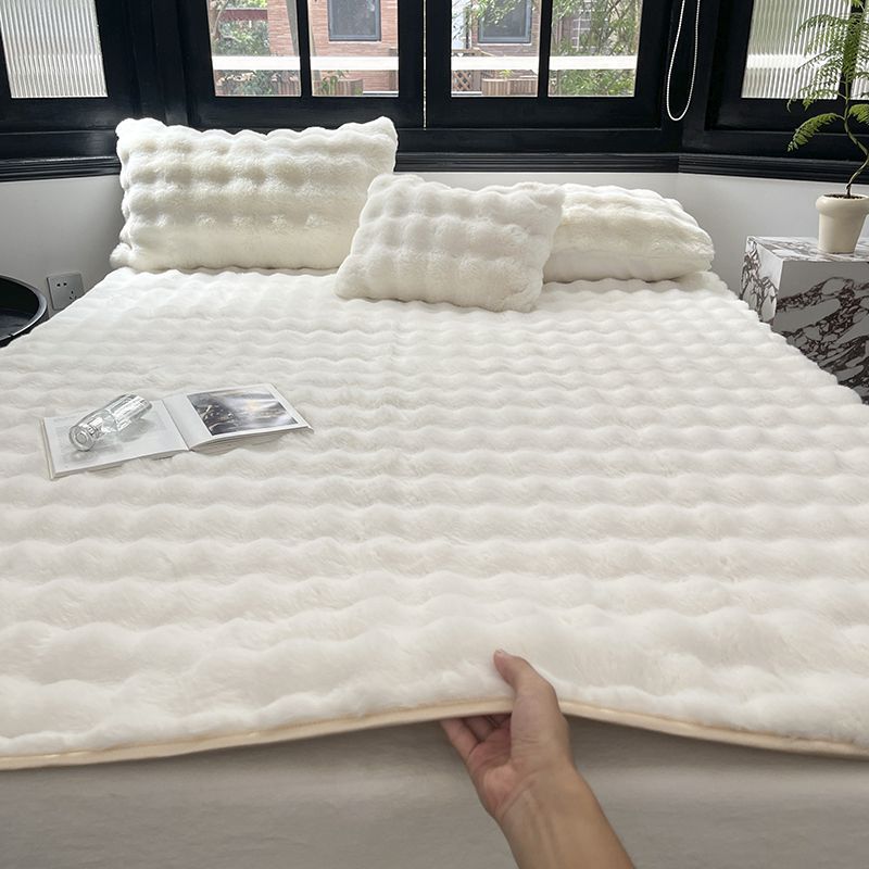 Padded microfiber mattress topper with wave stitching and plush surface
