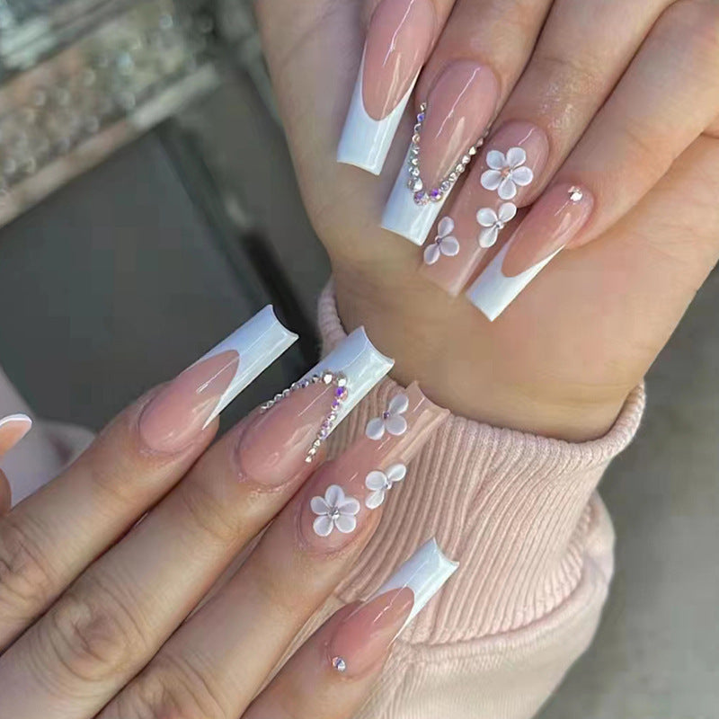 Artificial nail set with romantic floral decorations and glitter accents Stornfield