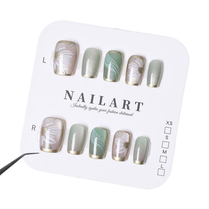 Artificial nails with floral accents and glamorous gold trim Stornfield