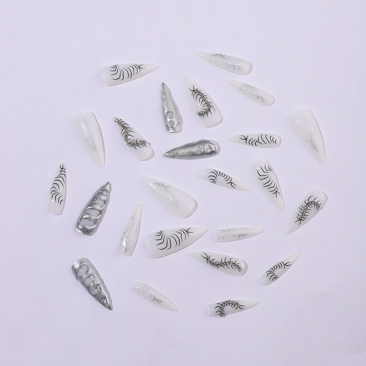 Creative nail art set with elegant floral designs and metallic accents Stornfield