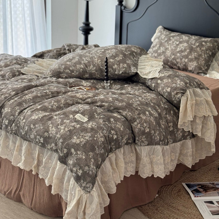 Floral quilted comfort bedspread with lace trim and decorative ruffle