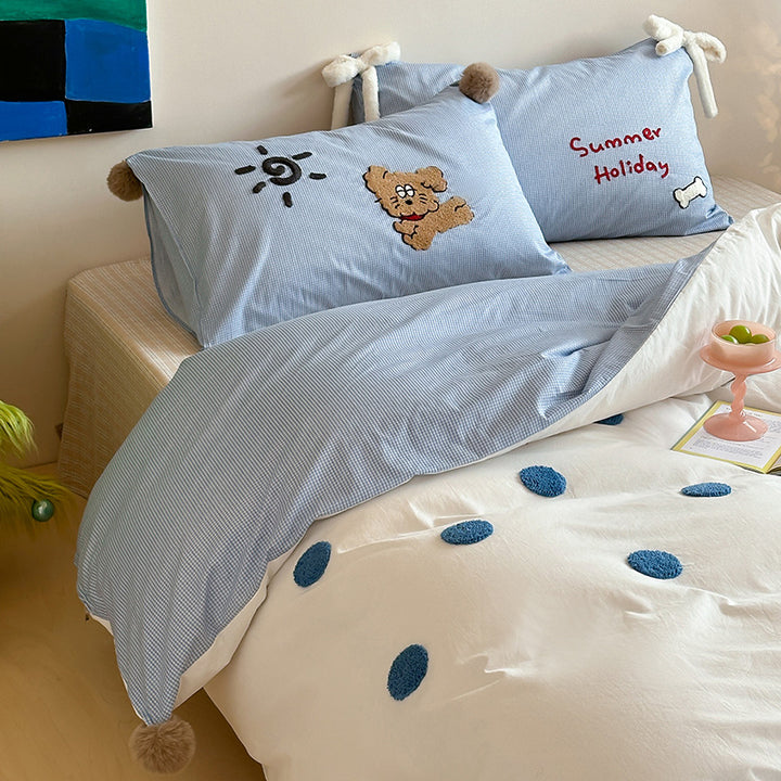 Children's bedding set with striped duvet cover, checkered decorative pillow, and plush application