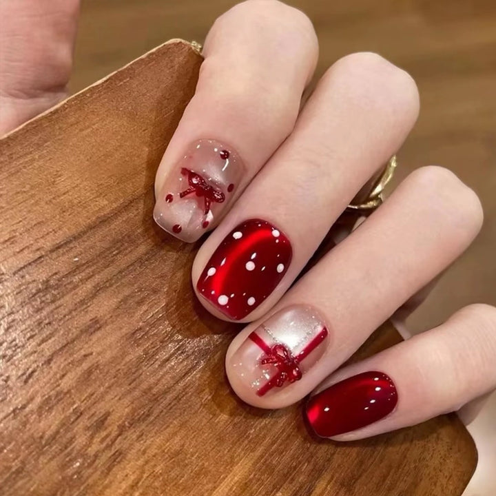 Artificial nail set with festive gift design and elegant glitter accents Stornfield