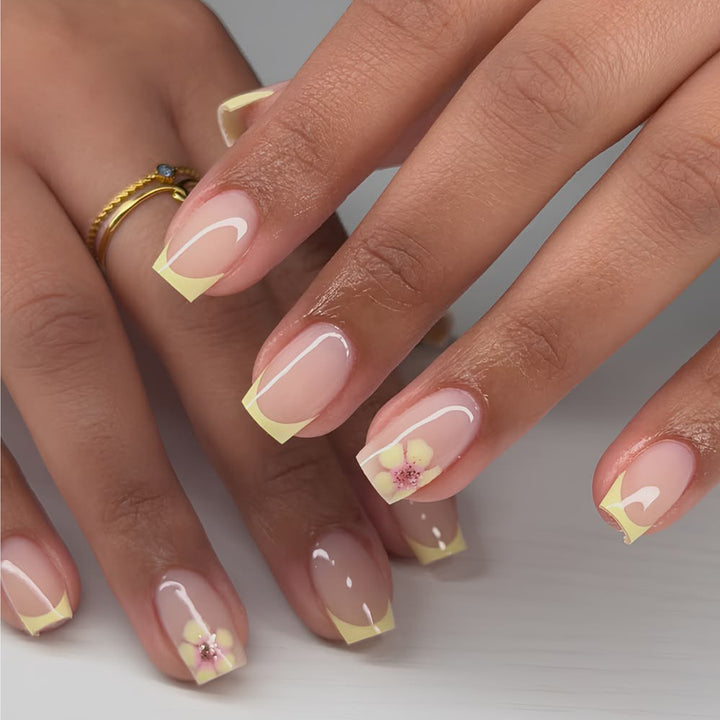Artistic French-tip nails with floral decorations Stornfield
