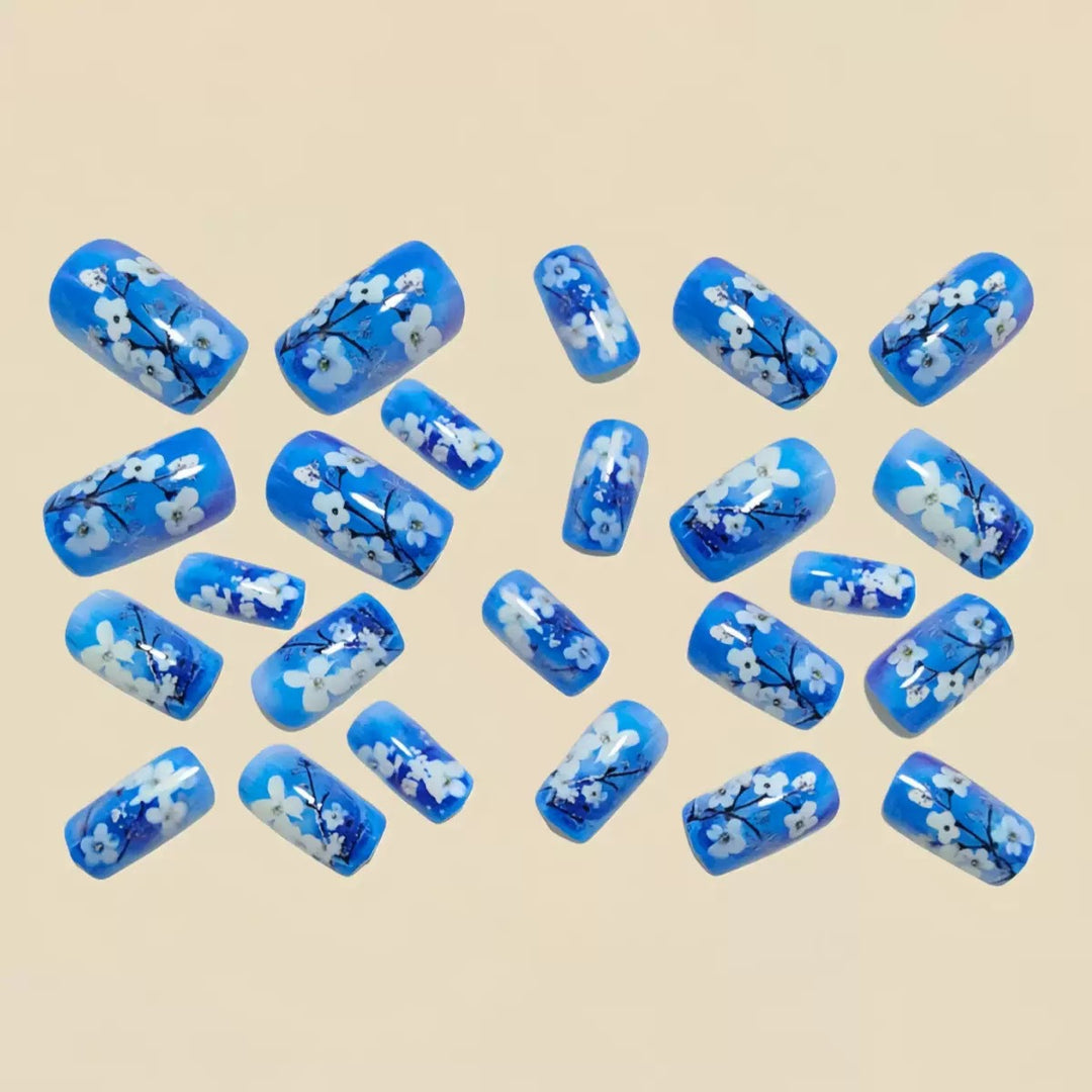 Artificial nail set with floral designs and glitter accents Stornfield
