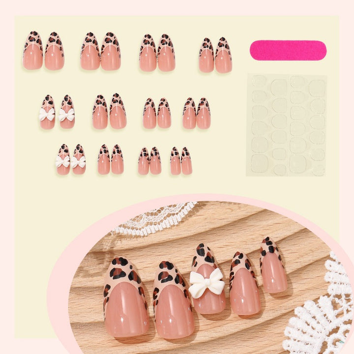 Artificial nail set with elegant leopard design and playful bow accents Stornfield