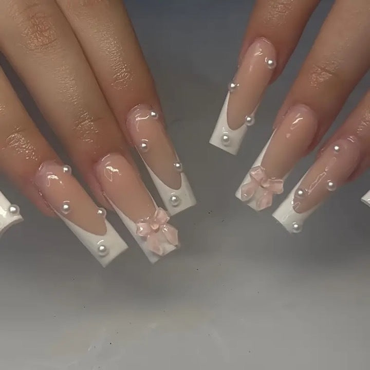 Artistic nail extensions with pearls and bows decorations Stornfield