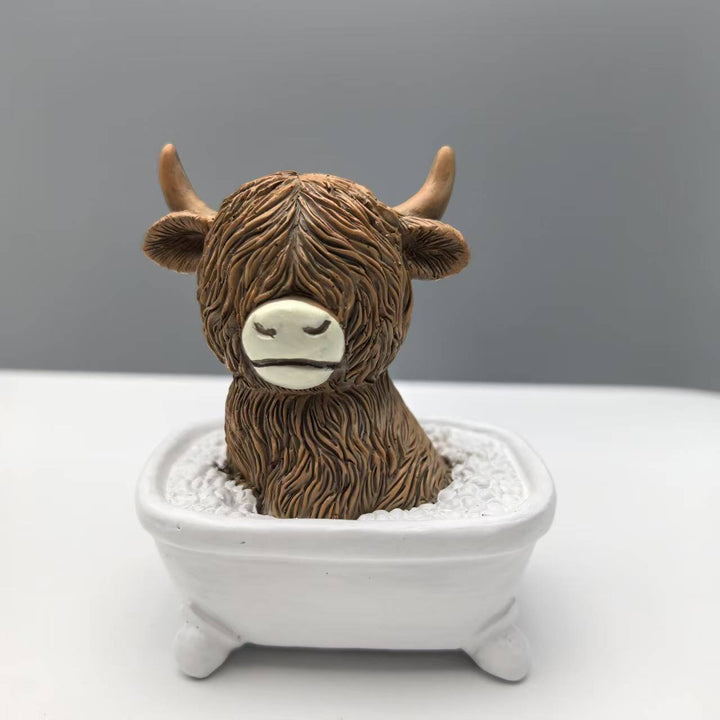 Funny decorative figure of a Highland cow in a bathtub Stornfield