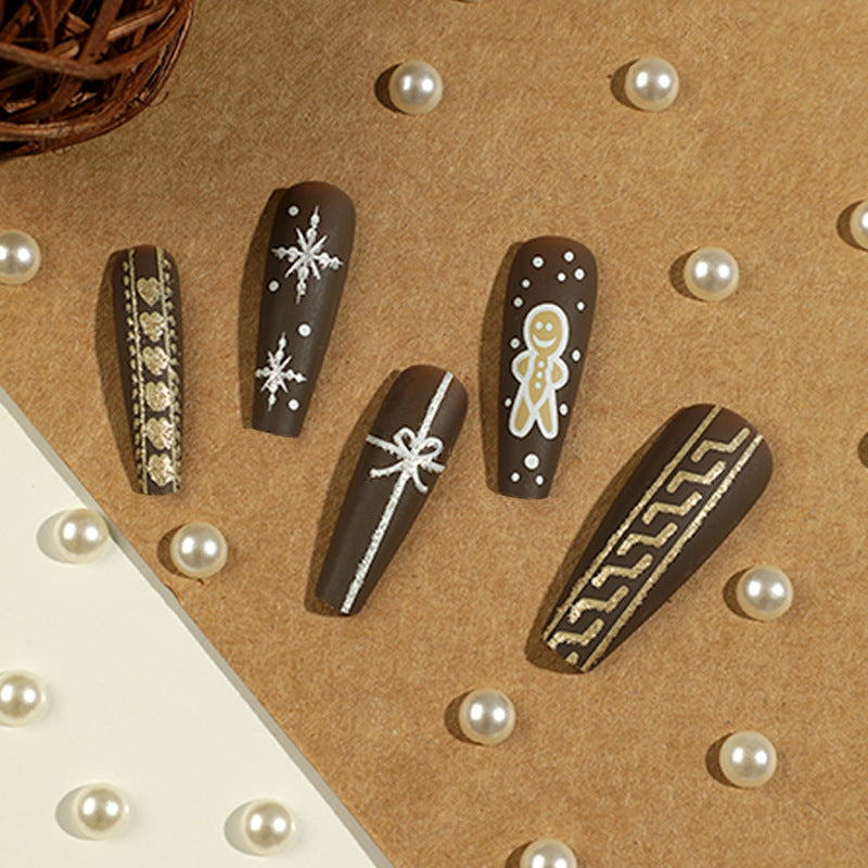 Artificial nail art with festive gingerbread design Stornfield