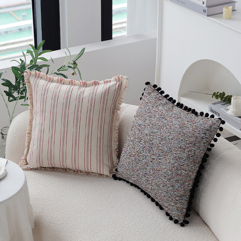 Playful decorative cushion with tassel edge