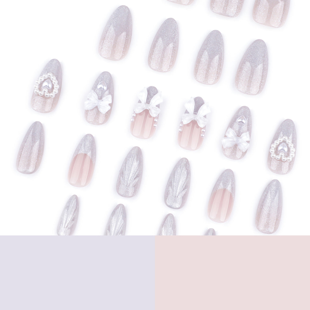 Artful nail decoration with pearl and bow accents Stornfield