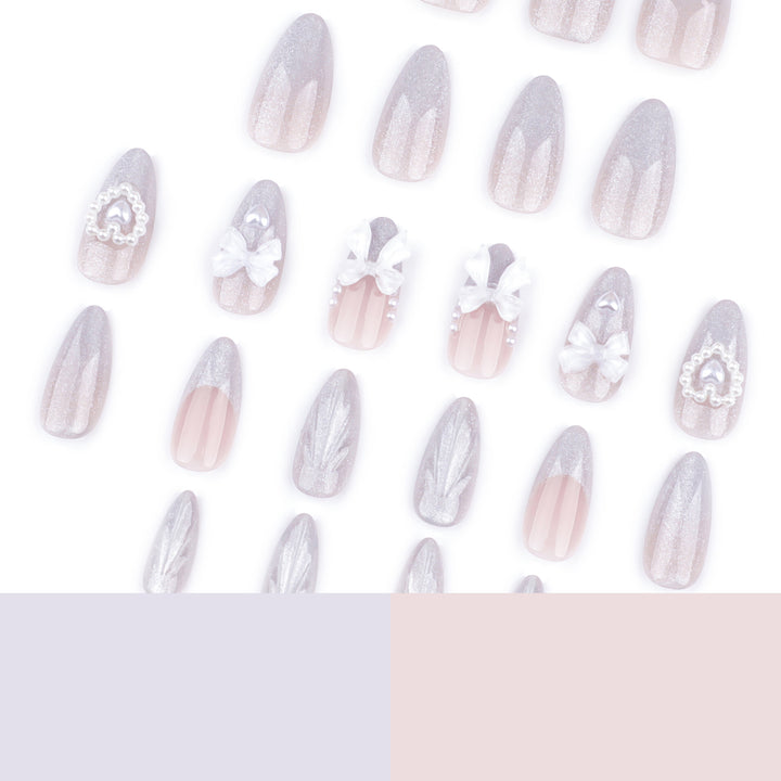 Artful nail decoration with pearl and bow accents Stornfield