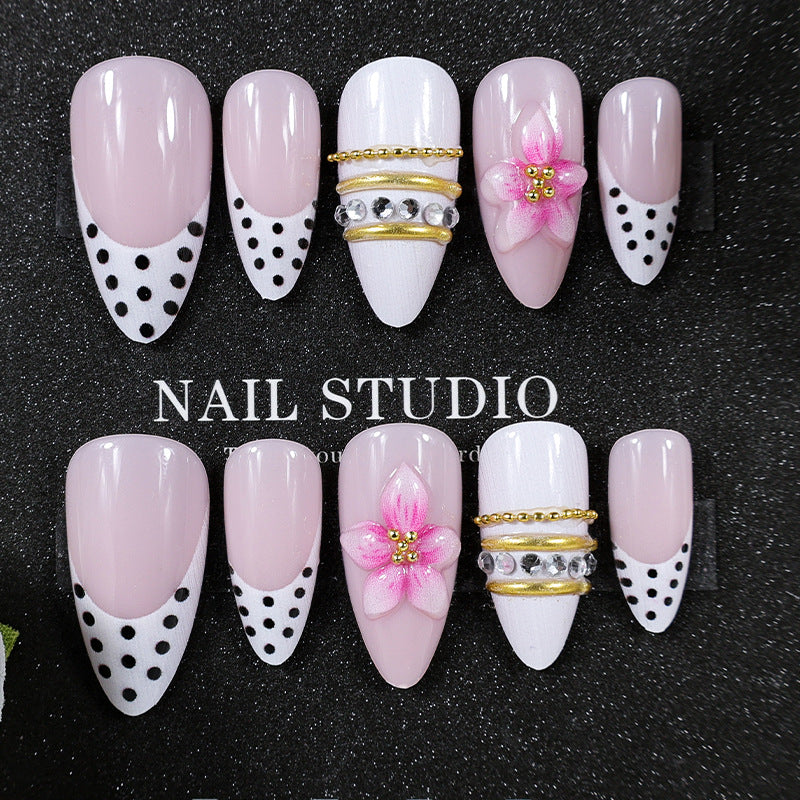 Acrylic nail set with romantic floral patterns and elegant glitter decorations Stornfield