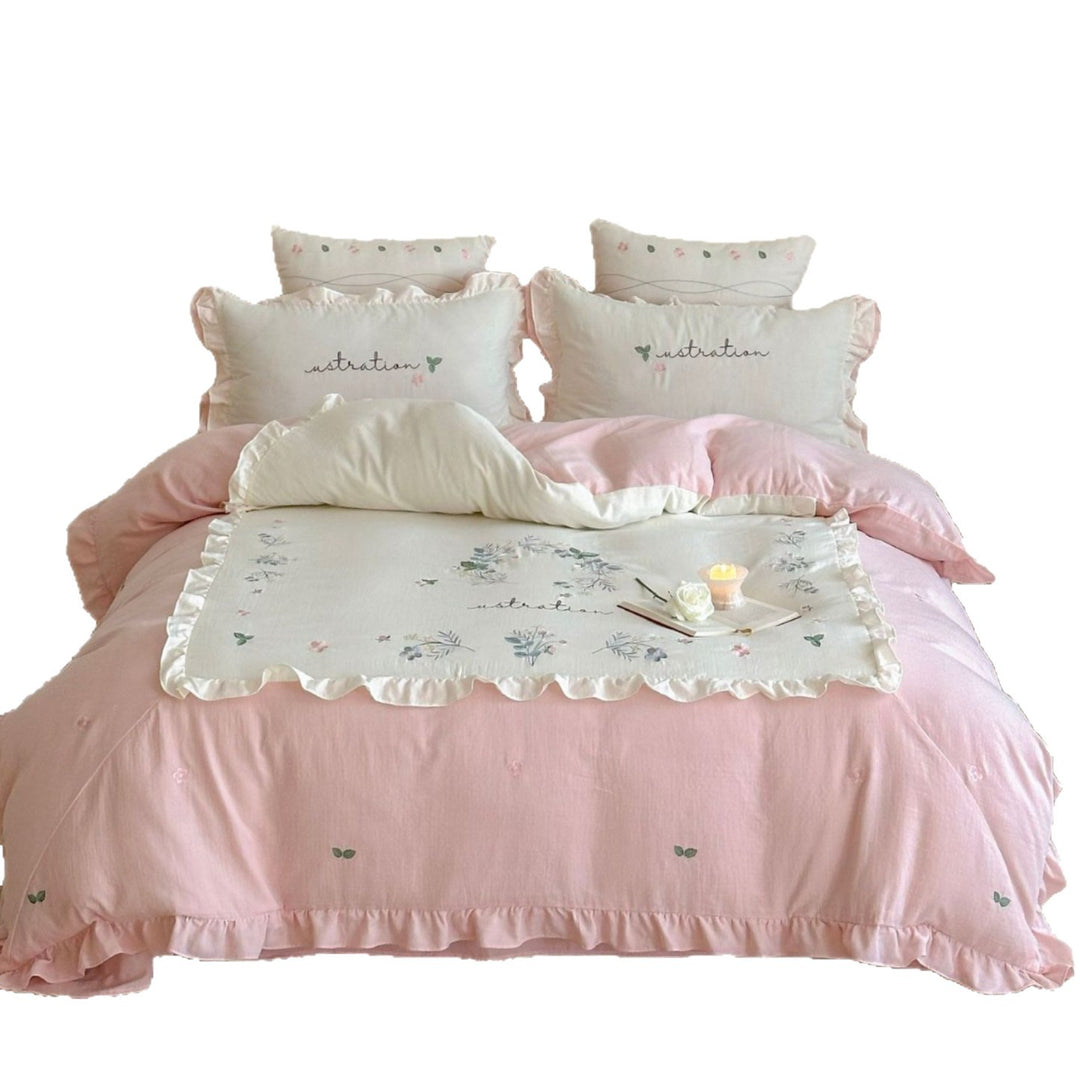 Bedding set with ruffles, embroidered middle cover and delicate flower application