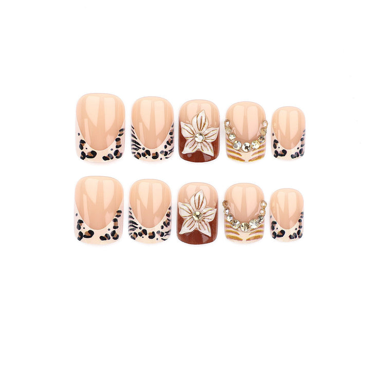 Artificial nail set with floral embellishments and elegant glitter details Stornfield