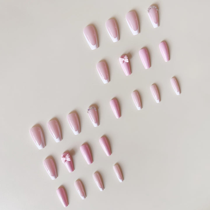 Artificial nail set with playful bows and glitter accents Stornfield